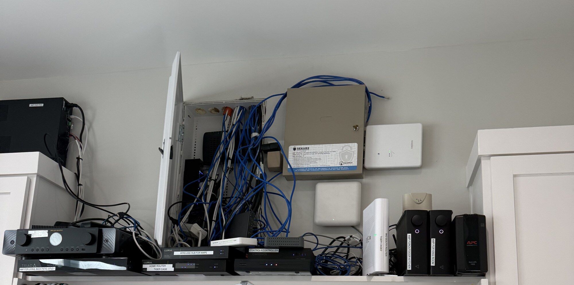 Before: a home's network, security panel and audio equipment